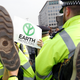 Police officers arrest a climate-change activist on Waterloo Bridge in London on April 18, 2019.